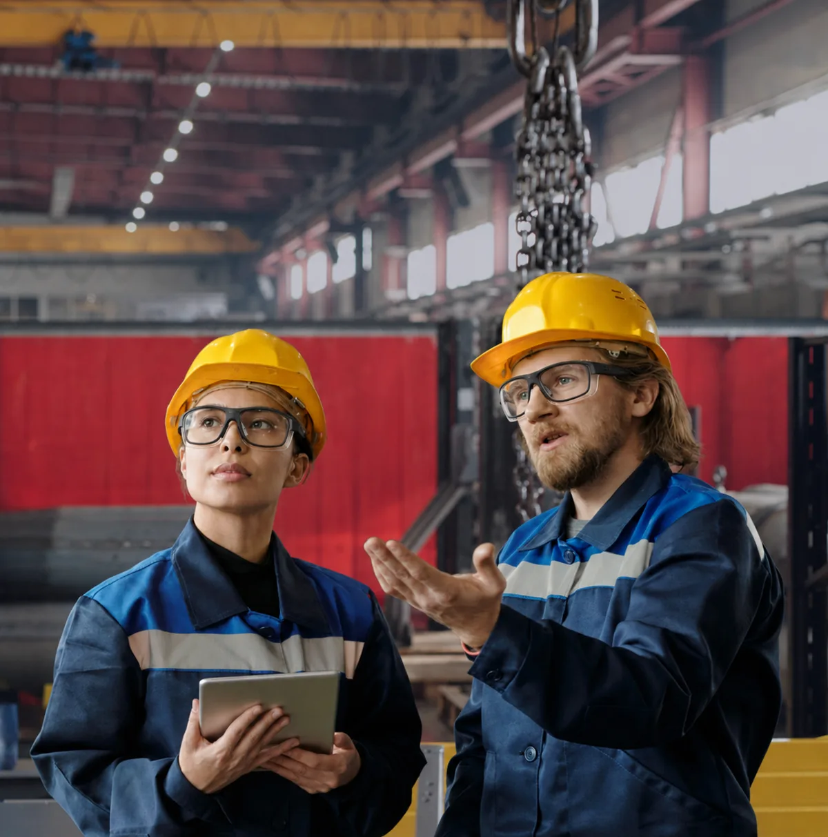 Two workers in hi-vis vests wearing smart glasses in a warehouse